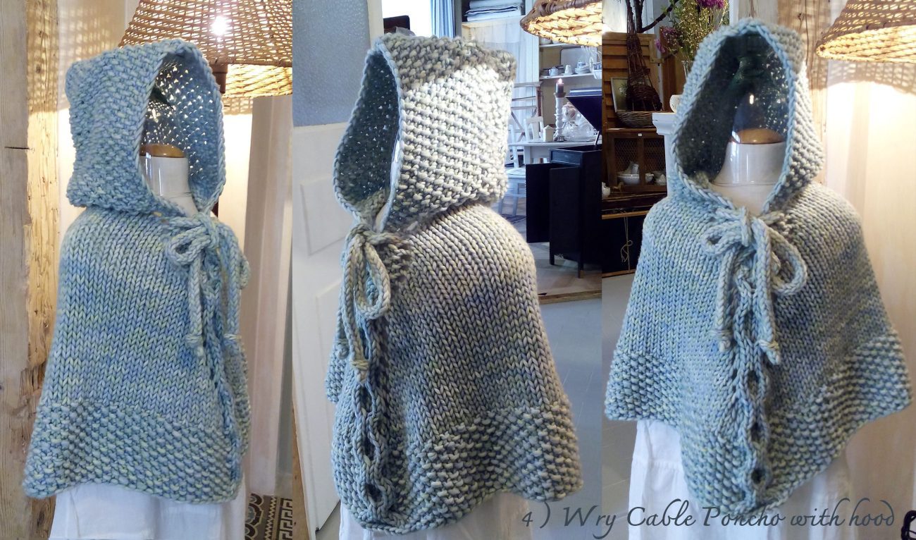 Hand-knitted baby and toddler poncho with hood, cable detail, and textured stitches – shown in chunky wool, from the Wry Cable Poncho PDF knitting pattern.