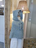 Hand-knitted baby and toddler poncho with hood, cable detail, and textured stitches – shown in chunky wool, from the Wry Cable Poncho PDF knitting pattern.