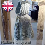 Hand-knitted baby and toddler poncho with hood, cable detail, and textured stitches – shown in chunky wool, from the Wry Cable Poncho PDF knitting pattern.