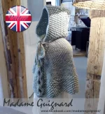 Hand-knitted baby and toddler poncho with hood, cable detail, and textured stitches – shown in chunky wool, from the Wry Cable Poncho PDF knitting pattern.